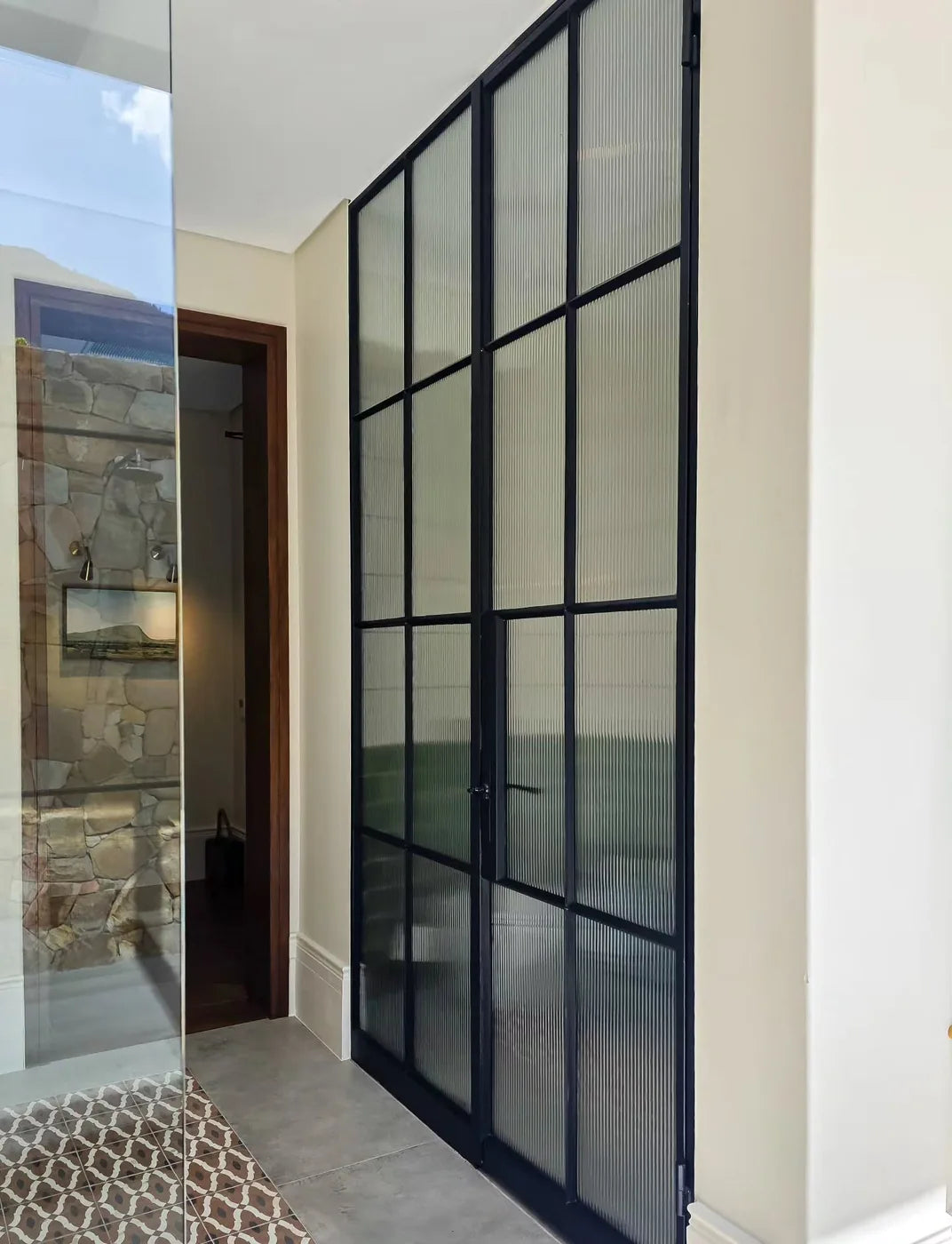 A little texture. A lot of impact. Wrought iron doors with reeded glass for a look that's both timeless and refined.