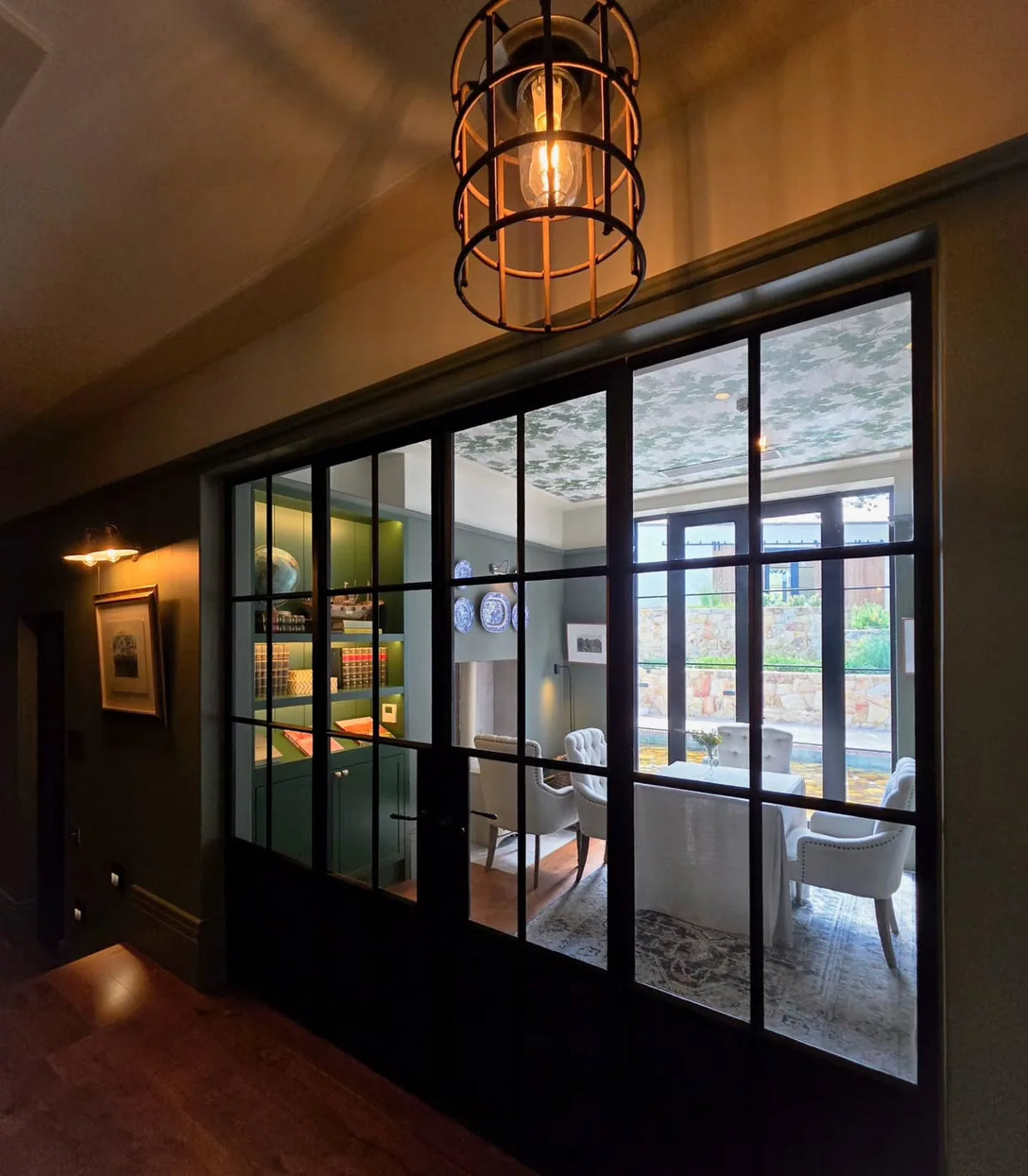 Some details completely transform a space. Custom steel framed doors bring definition without closing a room off, cre...