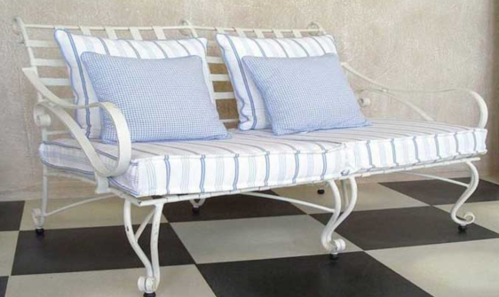 Outdoor wrought iron couch with striped cushions