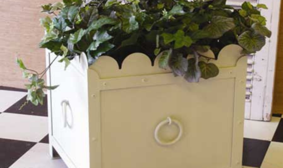 Decorative white wrought iron planter on patio 