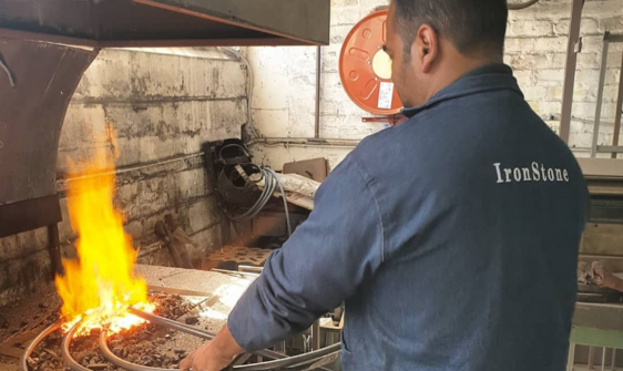 worker heating wrought iron metal